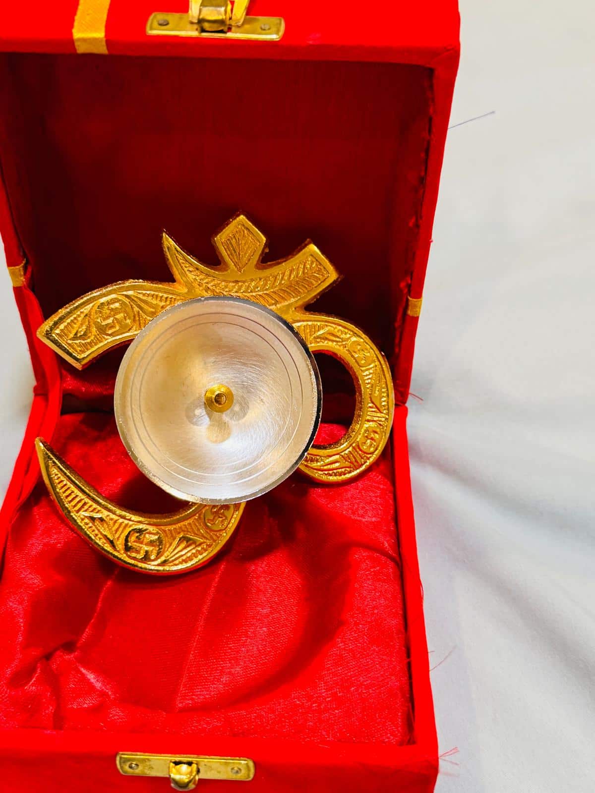German silver Om diya in a velvet box — german silver, beside something familiar, for scale