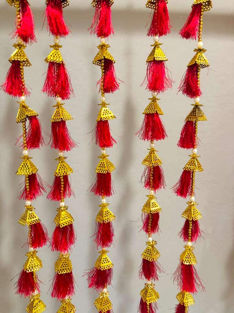 Golden jhumka with silk tassel garland — textile · set of 2 · 4 ft tall, beside something familiar, for scale